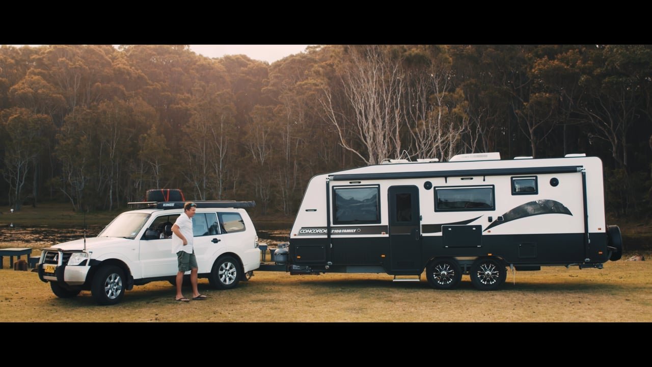 Caravan and four-wheel drive beside an Australian forest